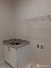 Laundry room on the second floor offers desirable utility sink.