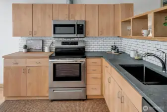 Caesarstone countertops with butcher block. Induction cooktop