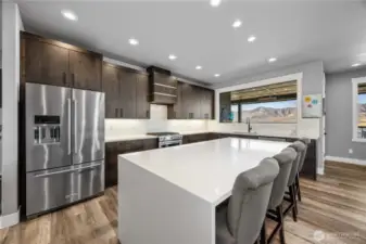 Kitchen with quartz Waterfall edge island, stunning cabinets and premuim appliances.
