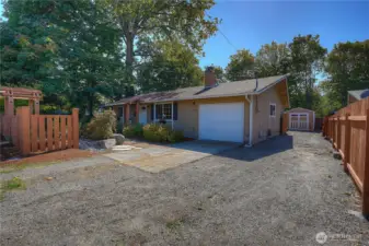 Attached garage, driveway, and RV parking along the side of the home.