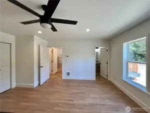 View of the Primary Bedroom Facing the Hall leading to the Kitchen and door to the En-Suite Bathroom