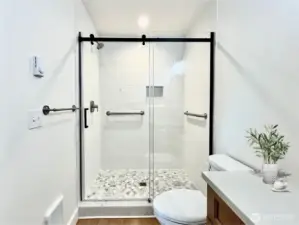 Just off the Primary Bedroom is this bright En-Suite with a Walk-In Shower with Glass Door. Virtually Staged.