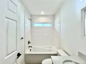 Full Bathroom between bedroom 2 and 3 with tub. Everything is shiny and new