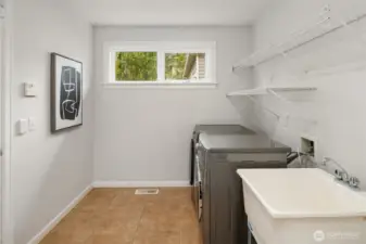 Spacious laundry room with utility sink is located on first floor.
