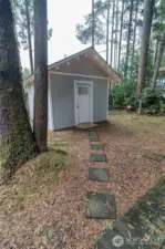 Fabulous bath house with shower, toilet, fridge/freezer, and washer and dryer.