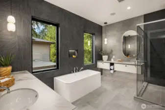 The primary bathroom includes heated floors, a soaking tub, a towel warmer & Axor fixtures.