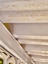 Look at the detailed flowers in the metal frame of the porch