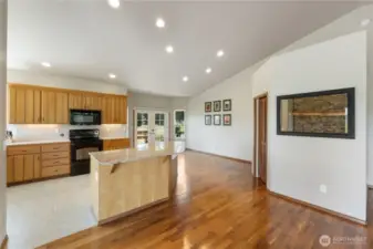 Stunning granite counters. Island with informal seating. Stay connected with guests at all times in this open concept floor plan. French doors open to the covered deck and outdoor seating.