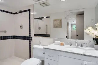 Lower level 3/4 bathroom features a dual headed shower stall.