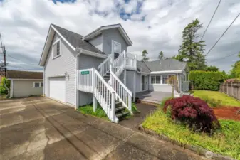 Tucked above the attached two-car garage, a separate guest suite provides its own private entrance via alley access.