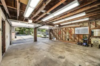 Detached 2 car garage with 1st door way to shop to the left, and 2nd left doorway to storage room.
