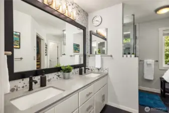 Luxurious primary bathroom offers heated tile floors, Italian marble walk-in shower with tile accents & a shower niche, plus transom windows to bring in even more light; quartz countertops with dual sinks, a private water closet, and sizeable walk in-closet add to the special features