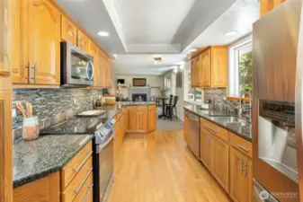 A chef's dream.... you can be in the kitchen but still part of all the fun!. Open to the living room and to the South Deck via a french door.  Luxury cabinetry with pull outs and an abundance of storage! Newer Stainless Steel appliances, tile backsplash, granite countertops, with great lighting!