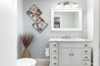 Primary compartmented bathroom. Updated vanity, mirror and lighting!