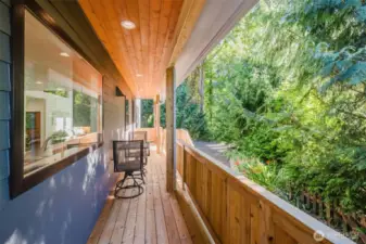 Step outside to enjoy the expansive wraparound deck, stretching along two sides of the home — ideal for morning coffee, entertaining, or simply taking in the forested surroundings.