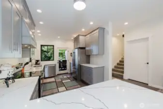 The kitchen is a showstopper, outfitted with top-of-the-line cabinetry, quartz countertops, and high-end finishes that blend beauty and functionality.