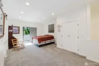 Upper loft. This corner is currently being used for a guest space. Notice the double door closet and glass sliding doors leading to a covered upper deck.