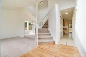 The refinished hardwoods, new carpet and fresh paint make this home feel bright and airy! Note the vaulted ceilings and grand staircase leading to the second floor. This is a functional layout that you are sure to enjoy!