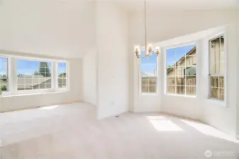 The open floor plan and vaulted ceilings are some of this home's best features! A friendly flow makes entertaining a breeze! Of course, more windows for more light are always appreciated during our PNW summer days!