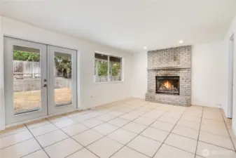 The family room has a grand wood burning fireplace and has some of the best views in the house overlooking the backyard and patio! To the right of the fireplace is the laundry room and garage. Let's take a look!