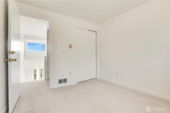 The light continues to flow throughout the upstairs and into the first bedroom. There is new paint, carpet and trim in here too!