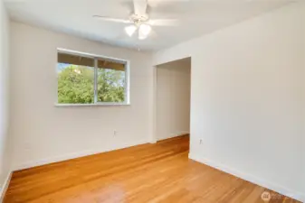 The second guest bedroom features hard flooring, new paint/trim and a walk-in closet! The ceiling fan helps keep the air moving as well.