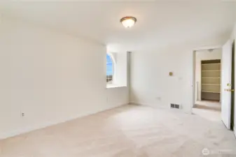 You could easily fit a king bed along with all your dressers a cozy chair for reading in this room. Down the hall is another linen storage closet.