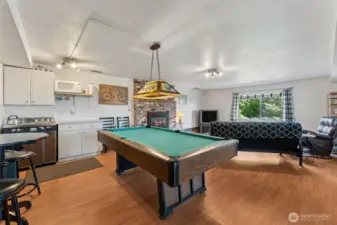 Love the lower-level rec room! Check out the kitchenette. Stove, sink, fridge, microwave & cabinets! Keep it as is or perhaps enhance it for a more formal ADU / Mother In Law.