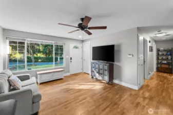 Updated windows, ceiling fan, and original hardwood floors leading into all 3 bedrooms.