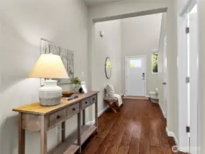 Spacious foyer with beautiful dark floors and seamless flow into the living and dining areas.