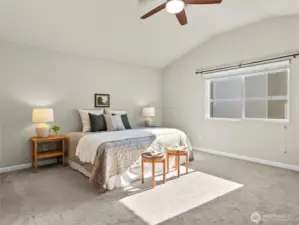 Generously sized primary suite with vaulted ceiling and soft natural light.