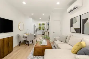 Sunlit open-concept living area designed for comfort and connection, featuring sleek finishes and warm hardwood tones.