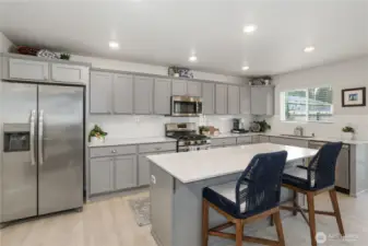 Can easily sit four regular sized bar stools.  These chairs are lg.