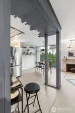 A contemporary solution frames the kitchen passage replacing what was once an obstructive kitchen wall. The result is a light-filled, open space.