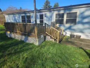 The deck on the front of the house is spacious and gets the sun from the South.