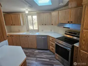 The kitchen has new appliances installed in 2023 and loads of cabinets and counter space as well as a large pantry.