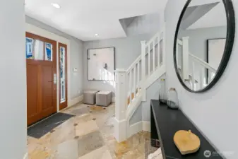 Entry is spacious with slate floors and space to greet and organize.