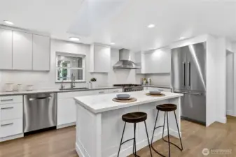 The center island is highlighted by a large skylight that is fitted with automatic blinds.