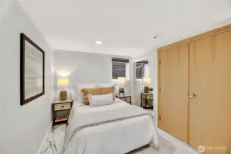 The first of two lower-level bedrooms.  This room features gorgeous tiled flooring that was installed in 2023.