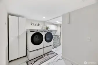 The laundry area was recently remodeled with lovely tiled flooring a useful utility sink and built-in clothes drying racks.