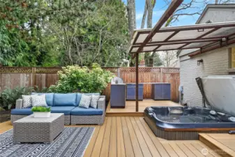 This area sits just off of the primary bedroom.  Enjoy evenings relaxing in the hot tub and cooking in your outdoor kitchen.