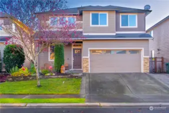 A stylish home with a spacious front yard and a 4-car garage