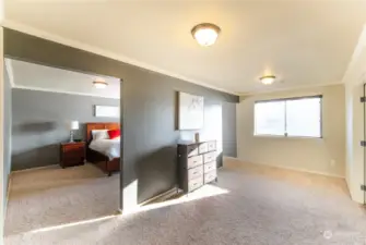 Spacious bedroom with a dedicated living area, offering comfort and privacy