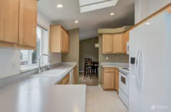 Kitchen features lots of counter space and storage in warm colors