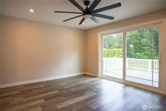Primary bedroom with expansive deck overlooking private backyard.