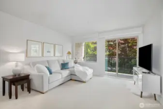 Deck off great room overlooks lush green yard.