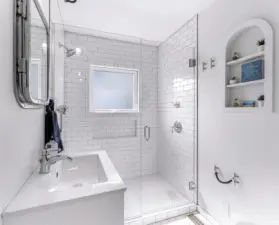 Convenient and clean walk in shower in the tastefully done bath