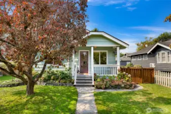 Flowers on either side of  an old school front porch