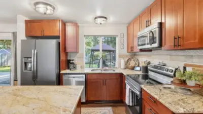 Slab granite countertops with large center island with breakfast bar and all stainless steel appliance package