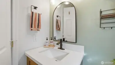 Updated bathroom vanity in full bathroom. Full tile shower surround.